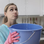 Home Flooded By Upstairs Or Roof Damage - Woman Holding