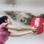 Photo Of Young Woman Holding A Bucket While Collecting Drops