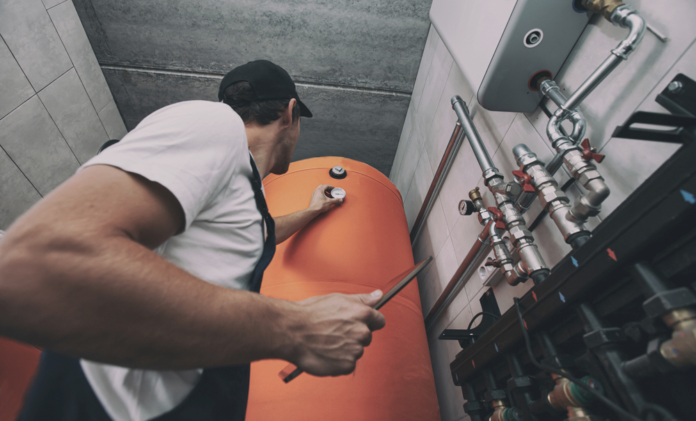 The technician checking the heating system