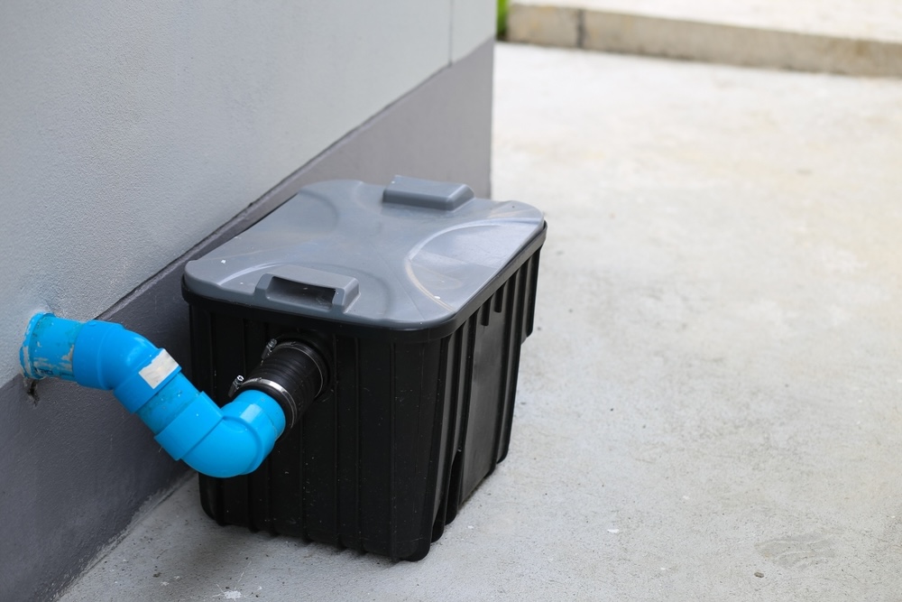 An image of a grease trap outside a residential kitchen